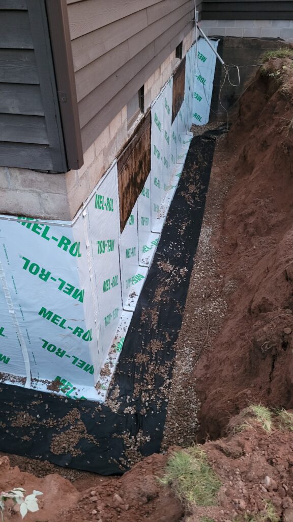 Image of drain tiles on a house during the excavation process