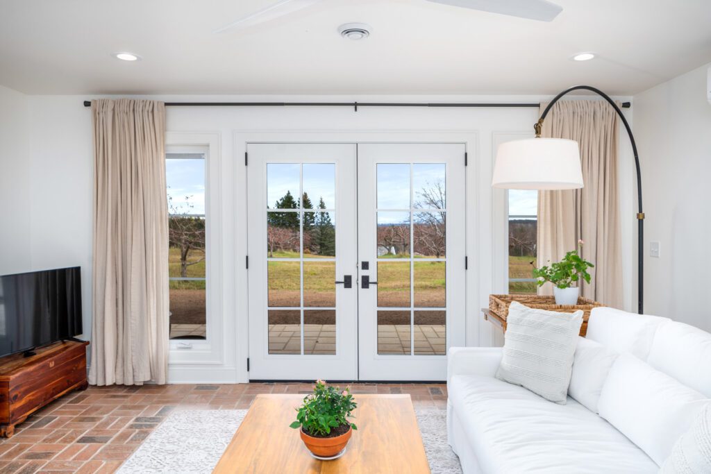 Image of a living room with french doors and big windows.